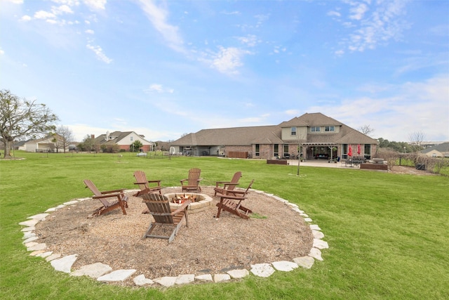 view of yard with an outdoor fire pit and a patio area