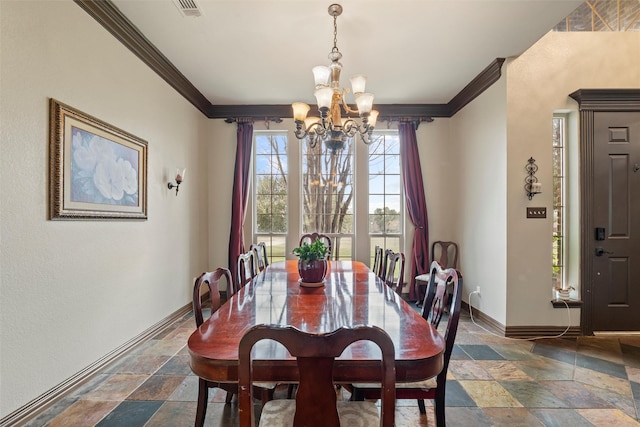 dining area with baseboards, ornamental molding, a notable chandelier, and stone tile floors