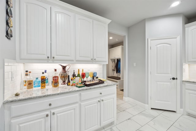 kitchen featuring marble finish floor, white cabinetry, and recessed lighting