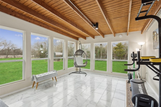 unfurnished sunroom featuring wood ceiling, rail lighting, and beam ceiling