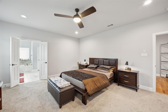 bedroom with light carpet, visible vents, and recessed lighting