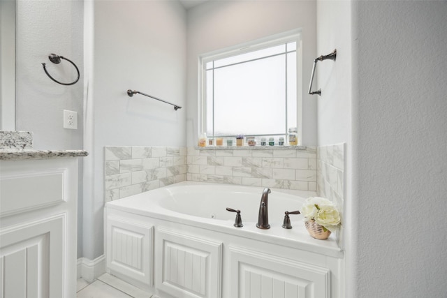 bathroom featuring a tub with jets