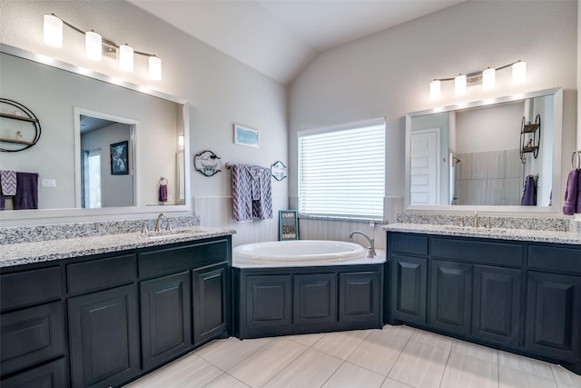 full bath featuring vaulted ceiling, tiled shower, a sink, and a garden tub