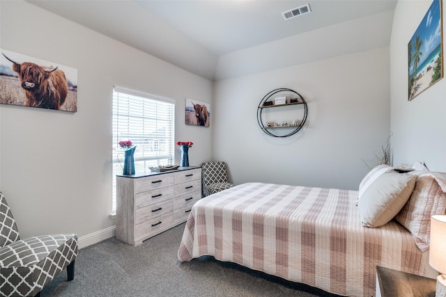 carpeted bedroom with visible vents and baseboards