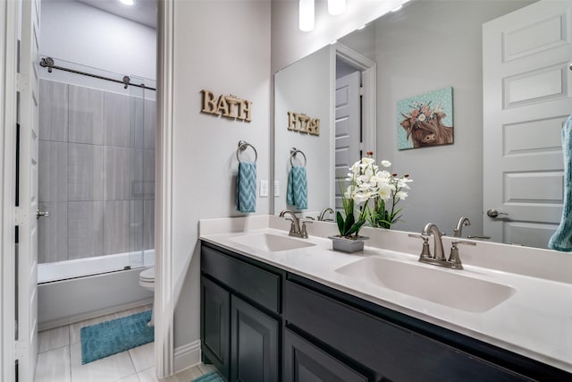 bathroom featuring toilet, combined bath / shower with glass door, a sink, and tile patterned floors