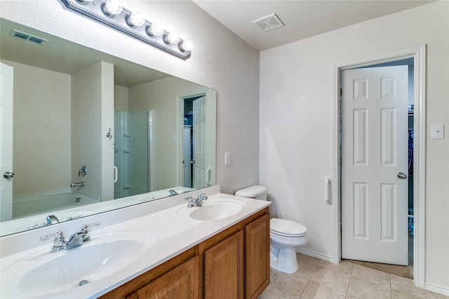 bathroom with a stall shower, a sink, and visible vents