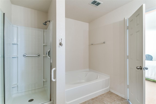 full bath featuring a garden tub, a shower stall, visible vents, and tile patterned flooring