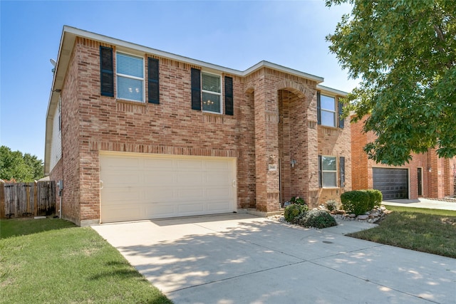 view of front of property with driveway, a garage, fence, a front lawn, and brick siding