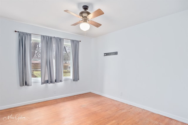 spare room featuring light wood finished floors and baseboards