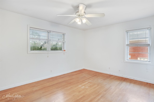 empty room featuring light wood-type flooring, ceiling fan, and baseboards