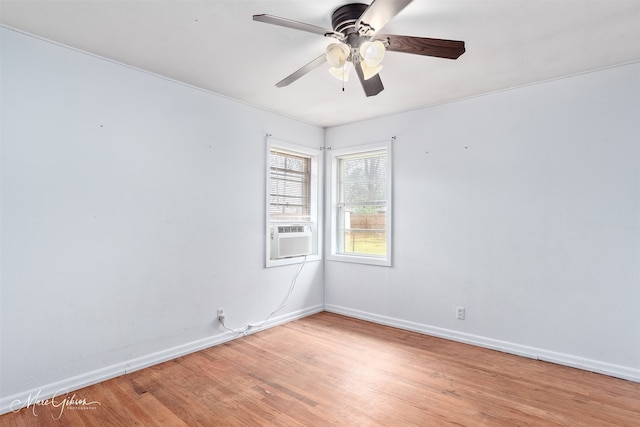 unfurnished room featuring light wood-style floors, cooling unit, baseboards, and a ceiling fan