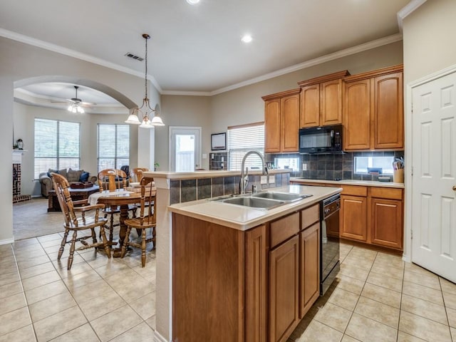 kitchen featuring arched walkways, light tile patterned floors, visible vents, a sink, and black appliances