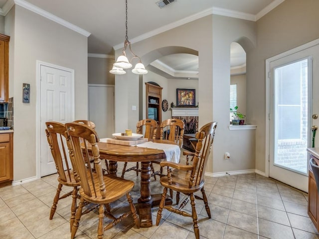 dining area featuring light tile patterned floors, ornamental molding, and a healthy amount of sunlight