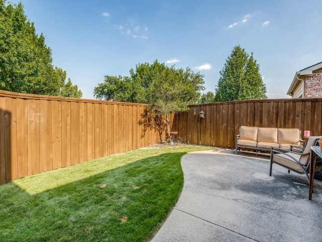 view of yard with a patio area, a fenced backyard, and an outdoor living space