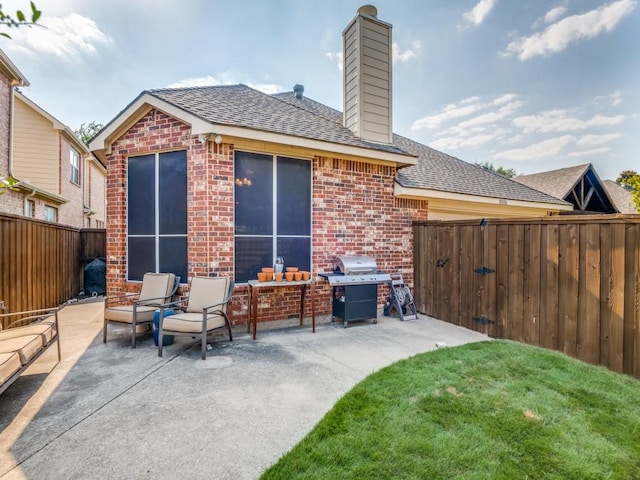 view of patio / terrace featuring a fenced backyard and a grill