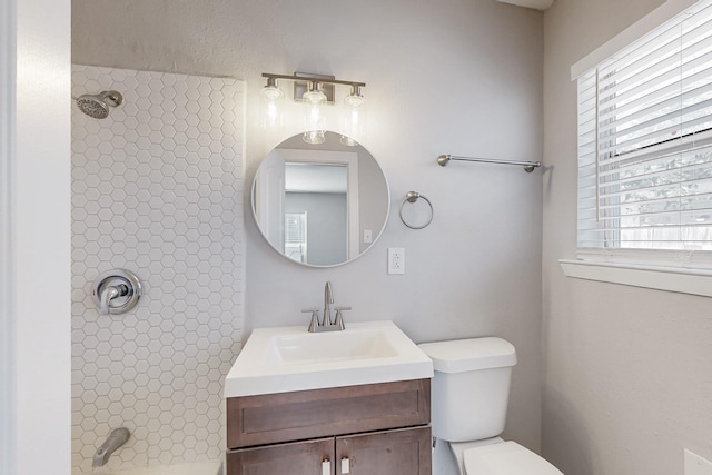 full bathroom with bathtub / shower combination, vanity, and toilet