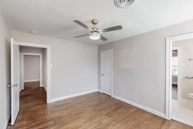 unfurnished bedroom featuring wood finished floors, a ceiling fan, visible vents, baseboards, and a closet