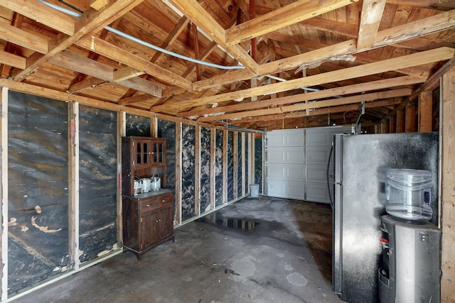 interior space with a garage and freestanding refrigerator