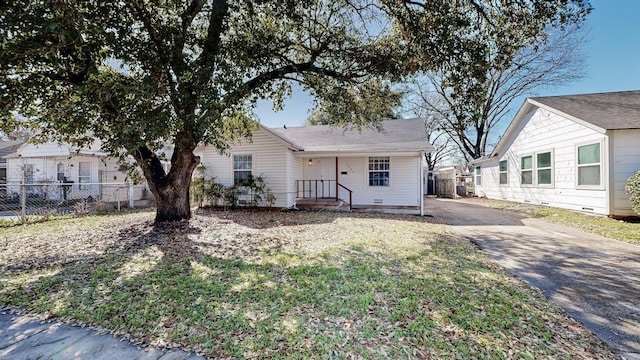 view of front of home featuring driveway and fence