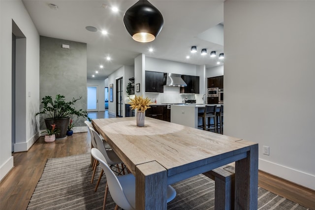 dining space featuring baseboards, dark wood-style flooring, and recessed lighting