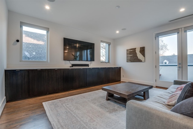 living area with french doors, recessed lighting, visible vents, wood finished floors, and baseboards