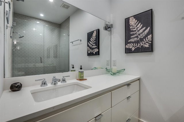 full bath featuring a shower stall, visible vents, and vanity