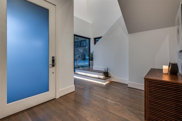 foyer entrance with wood finished floors and baseboards