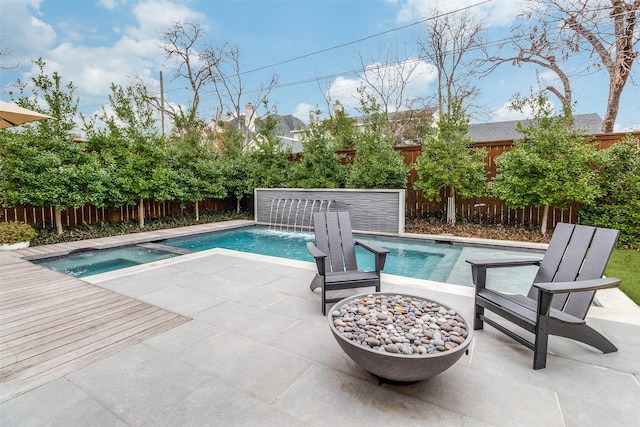 view of swimming pool featuring a fenced in pool, a patio area, a fenced backyard, and an in ground hot tub