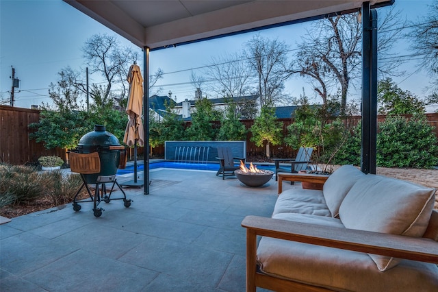 view of patio featuring a fire pit and a fenced backyard