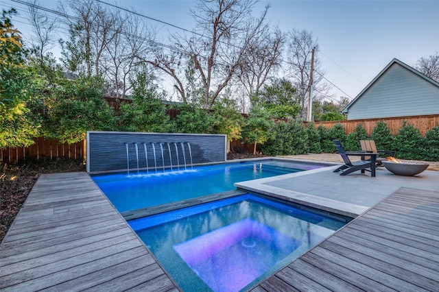 view of swimming pool featuring an in ground hot tub, a patio, a fenced backyard, and a fenced in pool