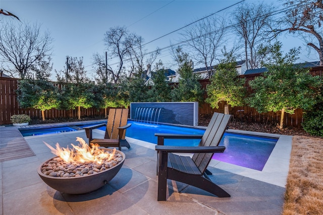 view of swimming pool featuring a fire pit, a patio, a fenced backyard, and a fenced in pool