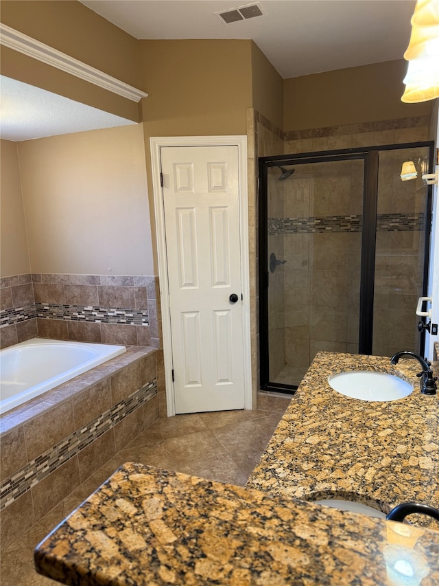 full bathroom with a garden tub, visible vents, a sink, and a shower stall