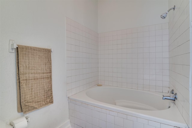 full bath featuring a relaxing tiled tub and walk in shower