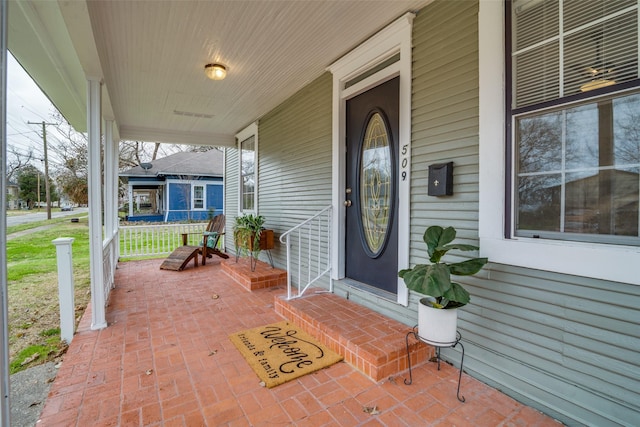 property entrance featuring covered porch