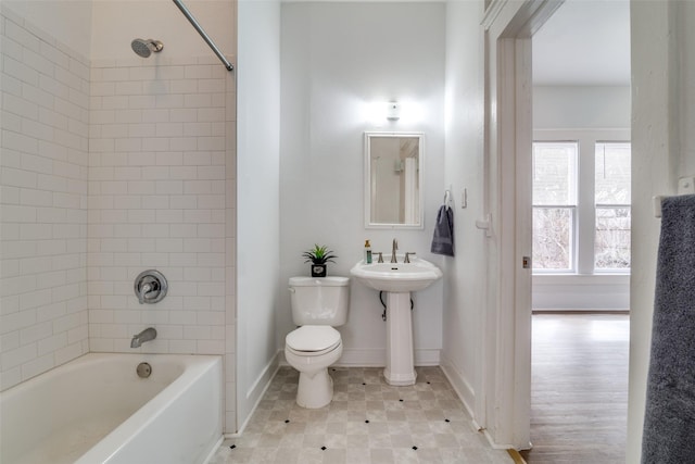 full bath featuring tub / shower combination, a sink, toilet, and baseboards