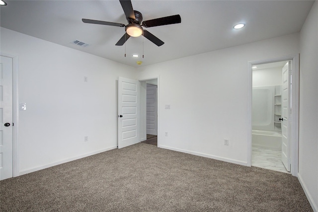 1422 W Austin St, Paris, TX 75460 - unfurnished bedroom featuring baseboards, visible vents, carpet flooring, and ensuite bathroom