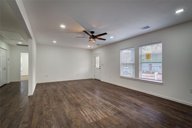 unfurnished living room featuring recessed lighting, visible vents, attic access, dark wood-type flooring, and baseboards