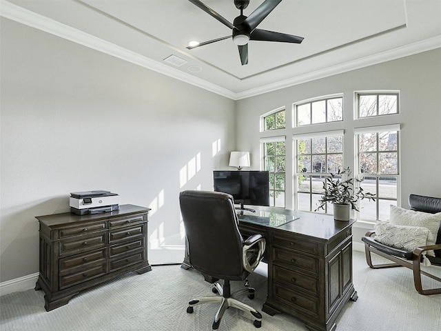 home office with baseboards, visible vents, a ceiling fan, light colored carpet, and ornamental molding