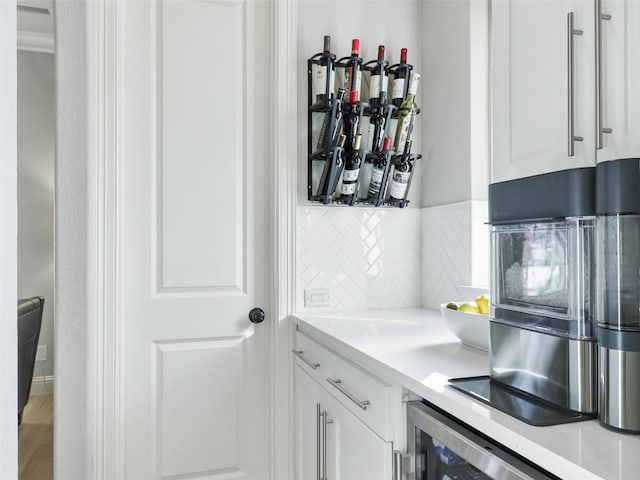 kitchen with light countertops, white cabinets, and decorative backsplash