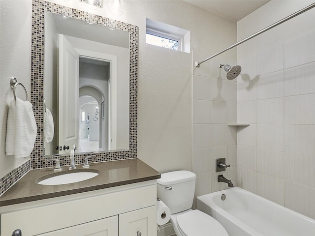 bathroom with toilet,  shower combination, and vanity