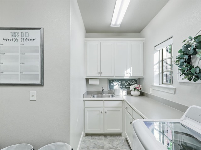 washroom featuring a sink and cabinet space