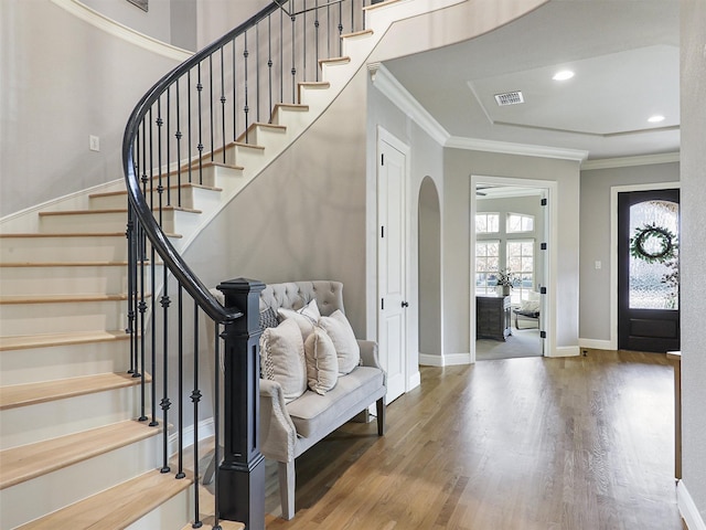 entrance foyer with ornamental molding, recessed lighting, baseboards, and wood finished floors