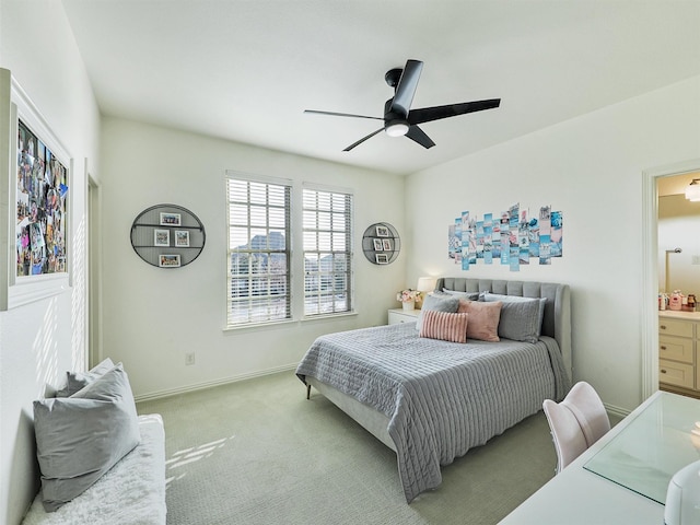 bedroom with ensuite bath, carpet, baseboards, and ceiling fan