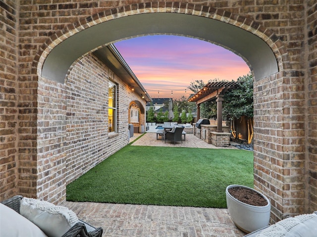 yard at dusk featuring a patio, fence, an outdoor living space, and a pergola