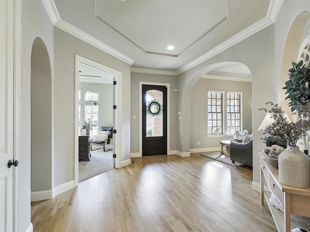 entrance foyer featuring crown molding, baseboards, and wood finished floors