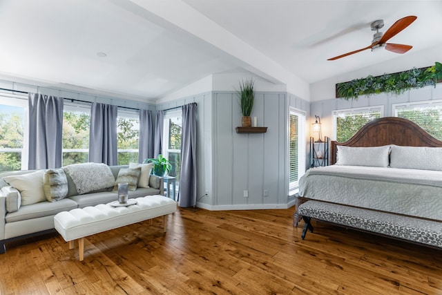 bedroom featuring vaulted ceiling, hardwood / wood-style floors, a ceiling fan, and baseboards