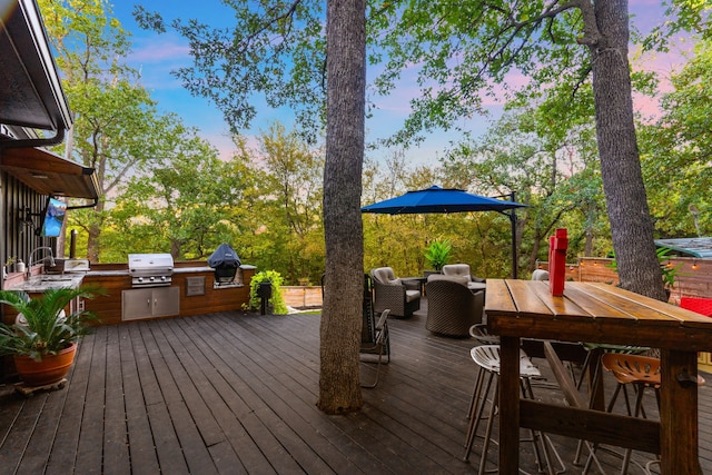 deck featuring outdoor lounge area, outdoor dining space, area for grilling, and a sink