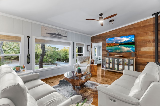 living room with lofted ceiling, ceiling fan, and wood finished floors