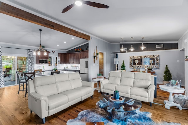 living room with lofted ceiling with beams, ceiling fan, wood finished floors, visible vents, and crown molding