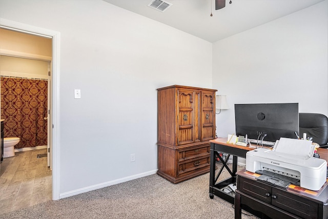 office with light carpet, ceiling fan, visible vents, and baseboards